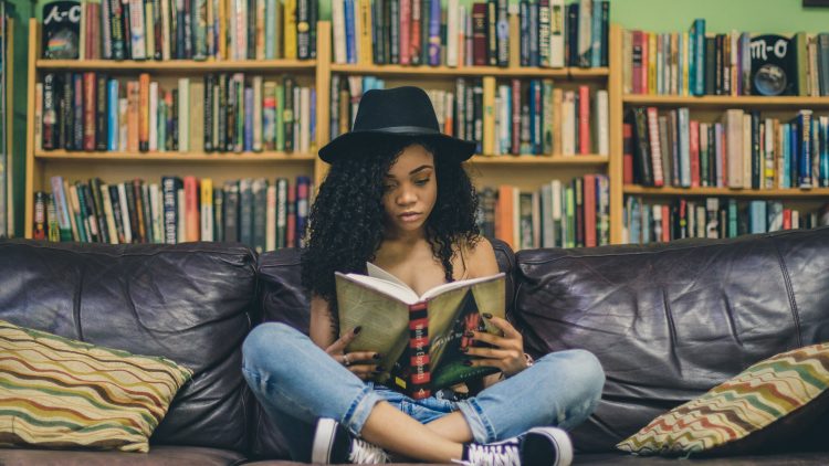 Woman reading a book in a library